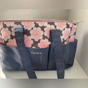 Carter’s baby nursery diaper bag, floral gray & pink, zips closed.